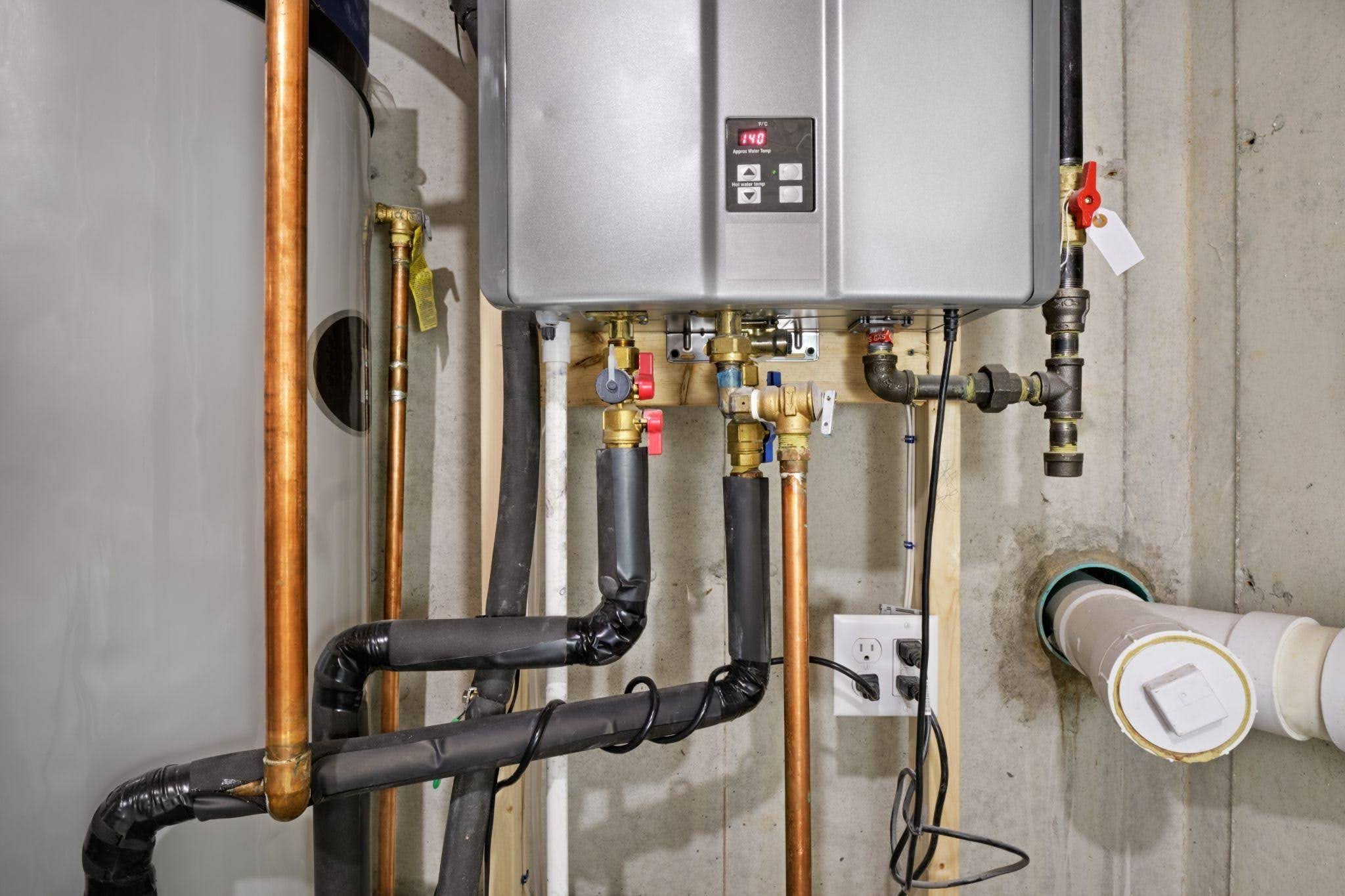 A water heater connected to a pipe illustrating the plumbing setup for hot water supply